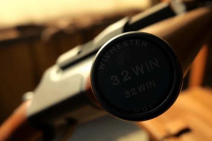 Detailed shot of a vintage 32WIN rifle in action, highlighting craftsmanship and its hunting legacy.